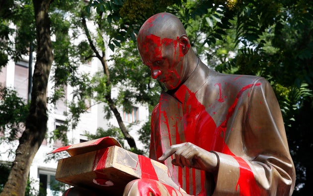 Red paint is seen on a statue of late Italian journalist Indro Montanelli, inside a park in Milan, northern...