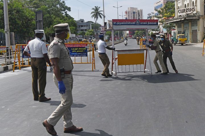 Police personnel prepare to install a barricade on a road after a lockdown was reimposed as a preventive measure against the spread of the COVID-19 coronavirus, in Chennai on June 19, 2020.