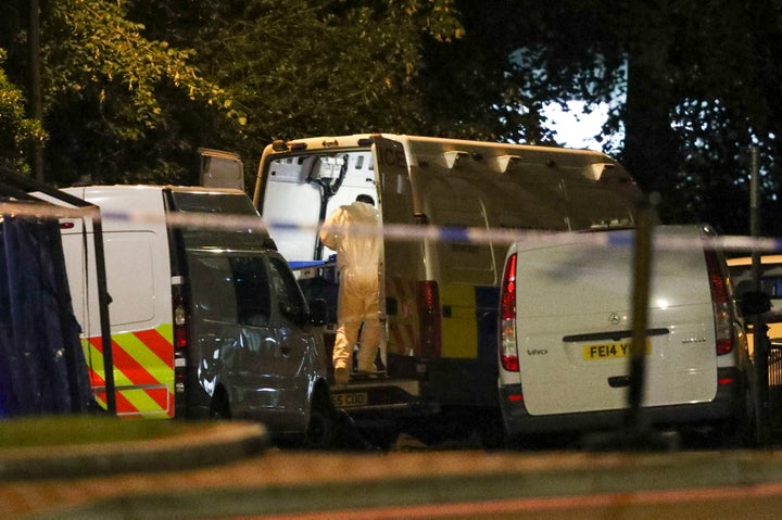 Forensic officers work at Forbury Gardens park on Sunday morning.