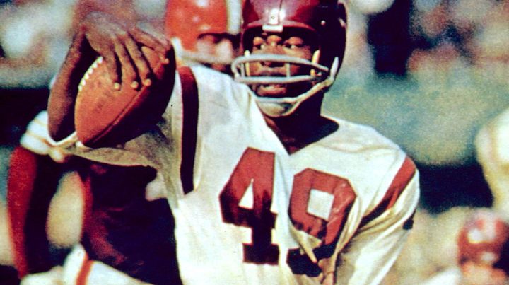 The Washington football team has retired the late Bobby Mitchell's jersey number. Here, he is pictured doing a spin move in a game against the Cleveland Browns in September 1963. He retired from playing in 1968 but stayed with the Washington team until his retirement in 2002.