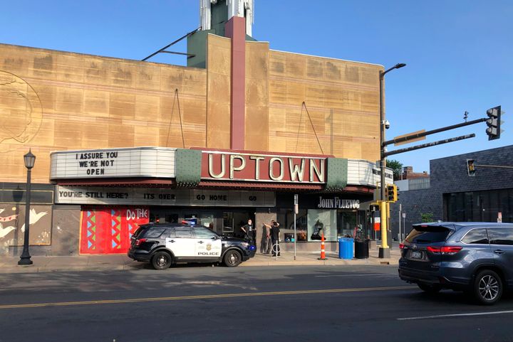 A police vehicle is parked outside the Uptown Theatre Sunday, June 21, 2020, following a shooting in Minneapolis' Uptown neighborhood.