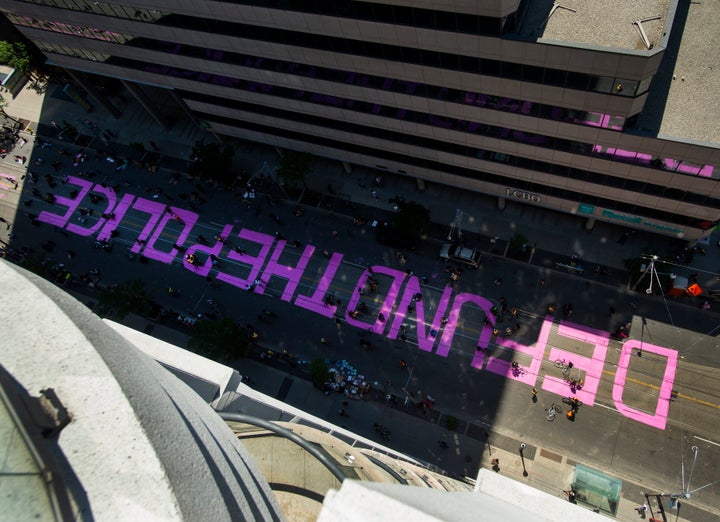 Thousands of Canadians attended a Black Lives Matter protest on June 19, where they painted "DEFUND THE POLICE" on the street in front of the City of Toronto police headquarters.