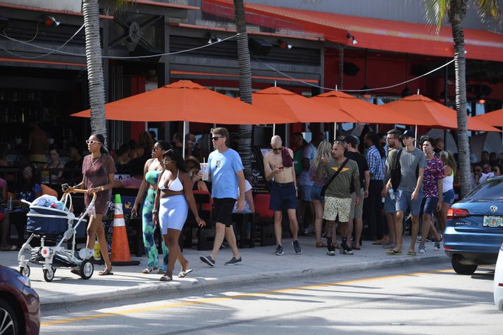 Crowded sidewalks Saturday in Fort Lauderdale Beach, Florida, show a lack of health precautions, such as social distancing an