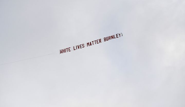 A plane flies over the stadium with a banner reading 'White Lives Matter Burnley' during the Premier League match at the Etihad Stadium, Manchester.
