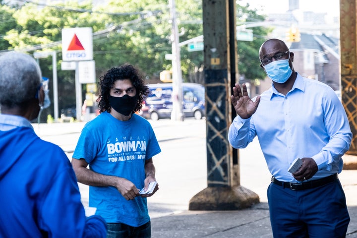 Jamaal Bowman, right, greets people outside of a subway station on Wednesday. He argues that Rep. Engel's seniority has not done enough for the district.