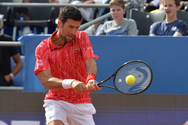Serbia's Novak Djokovic returns the ball during an exhibition tournament in Zadar, Croatia, Sunday, June 21, 2020. Tennis player Grigor Dimitrov says he has tested positive for COVID-19 and his announcement led to the cancellation of an exhibition event in Croatia where Novak Djokovic was scheduled to play on Sunday. 