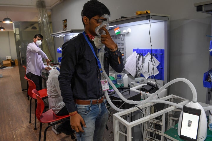 In this photo taken on March 25, 2020, an AgVa Healthcare employee demonstrates using a ventilator at the R&D centre in Noida.