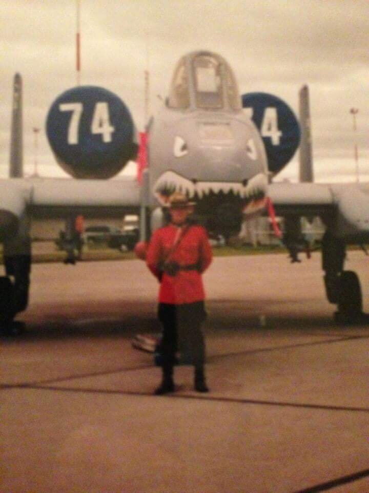 The writer posts in front of an A-10 Thunderbolt fighter plane.