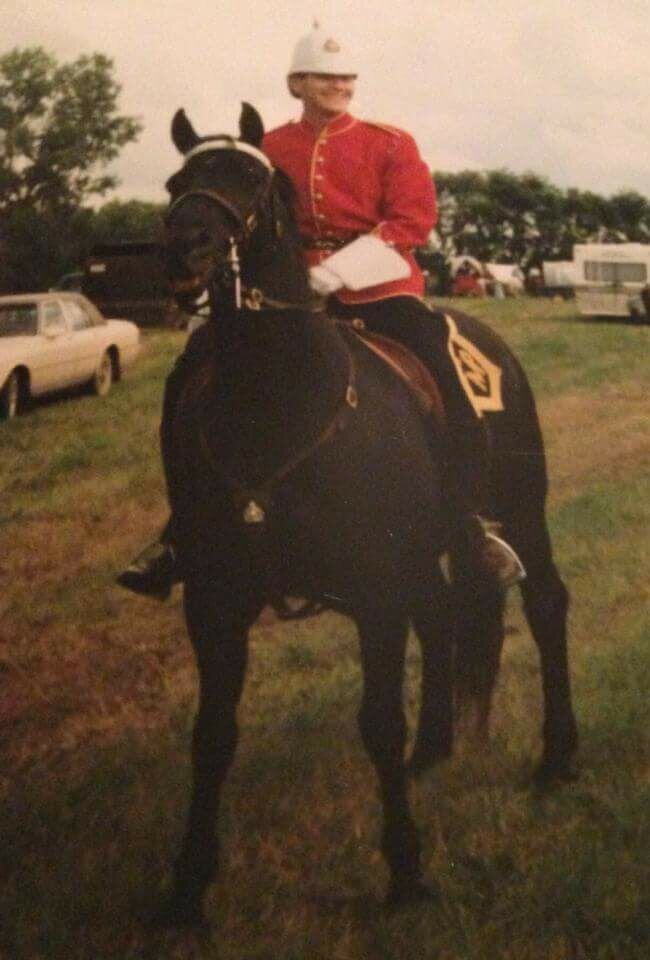 The writer wearing a period RCMP uniform on horseback.