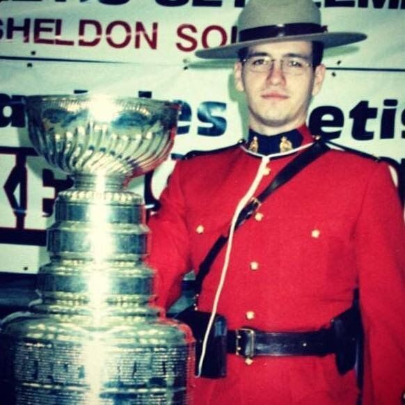 The writer poses next to the Stanley Cup in his RCMP red serge.