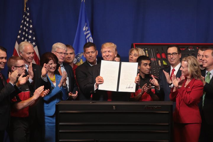 President Donald Trump signs an executive order to revamp the H-1B visa guest worker program and spur U.S. job growth during an April 2017 visit to the Snap-On tool headquarters in Kenosha, Wisconsin. Trump's goal to cut immigration was firmly set before the coronavirus disrupted the economy.