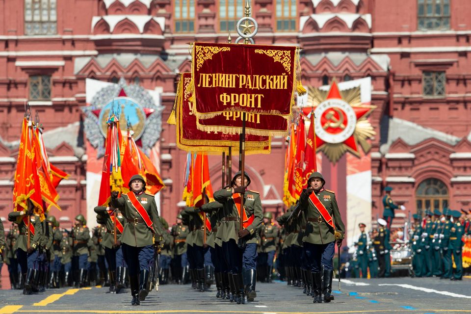 Russian soldiers wearing WWII-era uniforms march in Red Square during the Victory Day military parade...