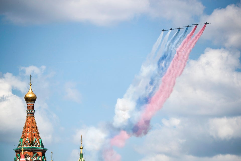 Russian warplanes fly over Red Square leaving trails of smoke in colors of national flag during the Victory...