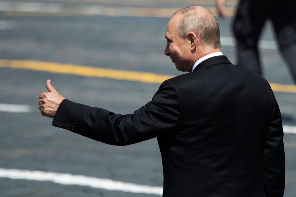 Russian President Vladimir Putin gestures as he leaves Red Square after the Victory Day military parade...