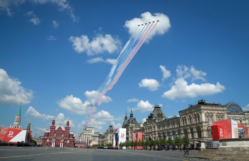 Russian warplanes fly over Red Square leaving trails of smoke in colors of national flag during the Victory...