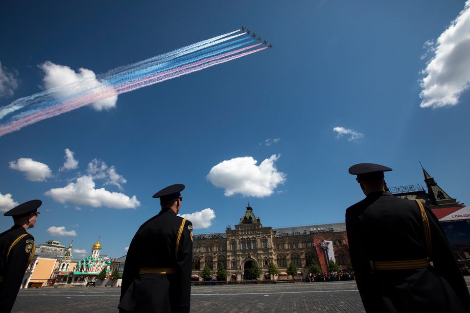 Russian Air Force Su-25 jets fly over Red Square leaving trails of smoke in colors of national flag during...