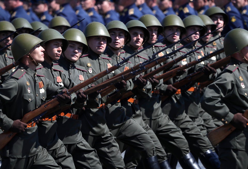 Russian soldiers dressed in Red Army World War II uniforms march toward Red Square during the Victory...