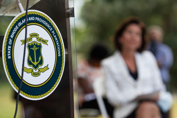 The seal of the State of Rhode Island decorates a podium as Gov. Gina Raimondo announces that she has signed an executive ord
