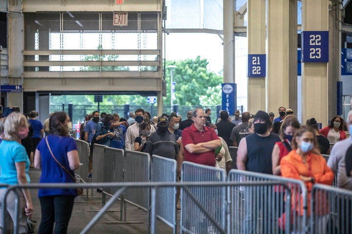 Fayette County voters wait in line to cast their ballots at Kroger Field in Lexington Tuesday.