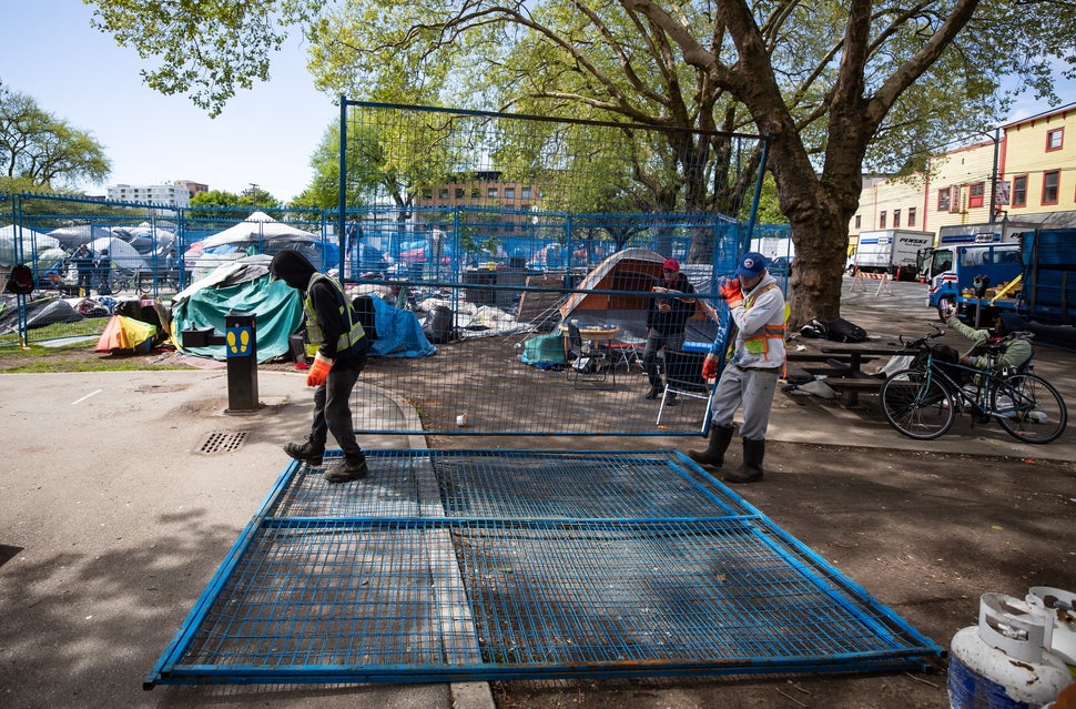 Workers deliver fencing to a homeless camp at Oppenheimer Park in the Downtown Eastside of Vancouver, on Wednesday, May 6, 20