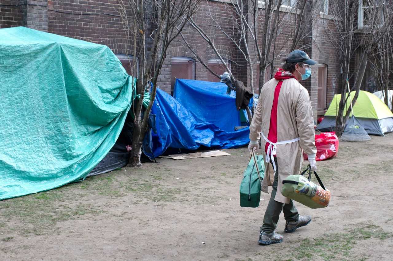 Doug Johnson Hatlem, a worker at The Sanctuary, a respite centre in Toronto, carries tents to be distributed to members of the homeless community on April 19 2020. 