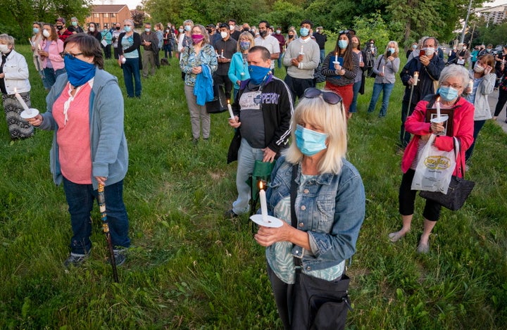Participants hold a vigil for COVID-19 victims at Orchard Villa long-term care home in Pickering, Ont. on June 15, 2020.