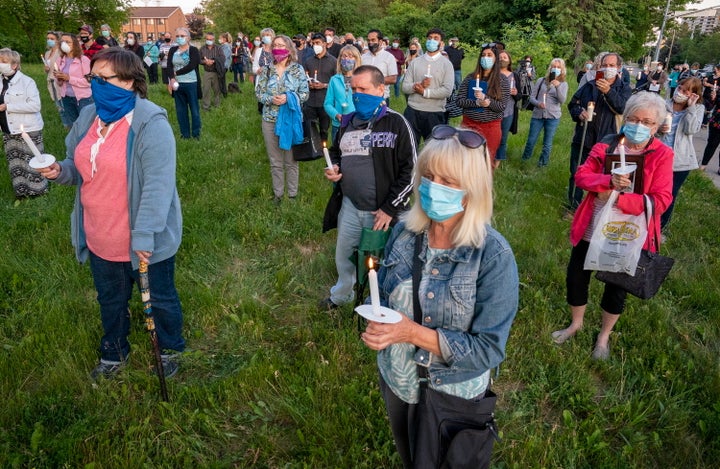 Participants hold a vigil for COVID-19 victims at Orchard Villa long-term care home in Pickering, Ont. on June 15, 2020. 