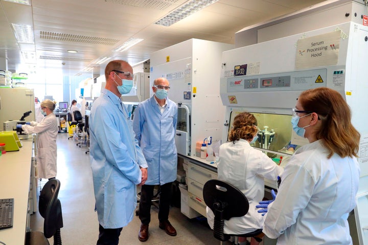 William, wearing a face mask, meets scientists including Christina Dold (R) during a visit to the manufacturing laboratory where a vaccine against the novel coronavirus COVID-19 has been produced at the Oxford Vaccine Group's facility. 