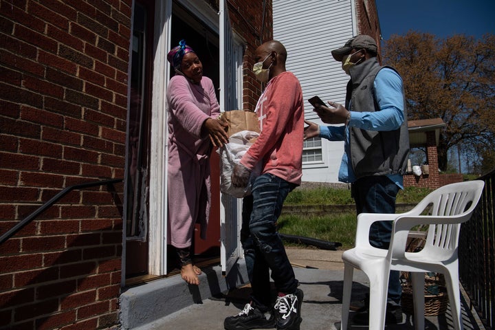 Volunteers deliver groceries to a woman in Washington, D.C., on April 6 amid the coronavirus pandemic. They knew where to go thanks to a mutual aid network set up in the U.S. capital to get help to poor and underserved communities at risk of the coronavirus.