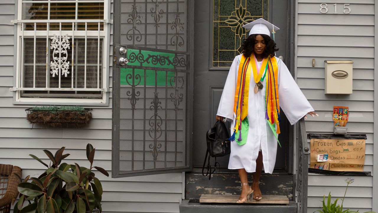 Satoriya Lambert walks out the door on her way to her high school graduation from Walter L. Cohen College Prep in late May. Satoriya was 3 when Hurricane Katrina devastated the city, forcing her family to flee. 