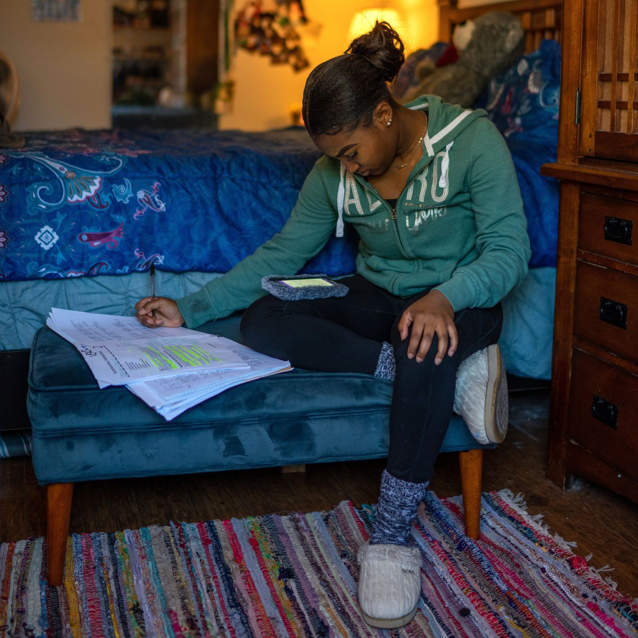 Satoriya Lambert does homework in her room after the coronavirus shuttered schools for the rest of the year in New Orleans. Satoriya was 3 when she and her family fled after Hurricane Katrina flooded the city.