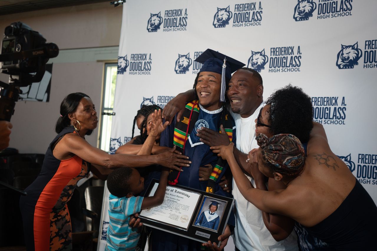 Jarrin Rainey celebrates with his proud family, including grandmother Sheila Rainey, left, after his graduation ceremony at Frederick A. Douglass High School in late May.