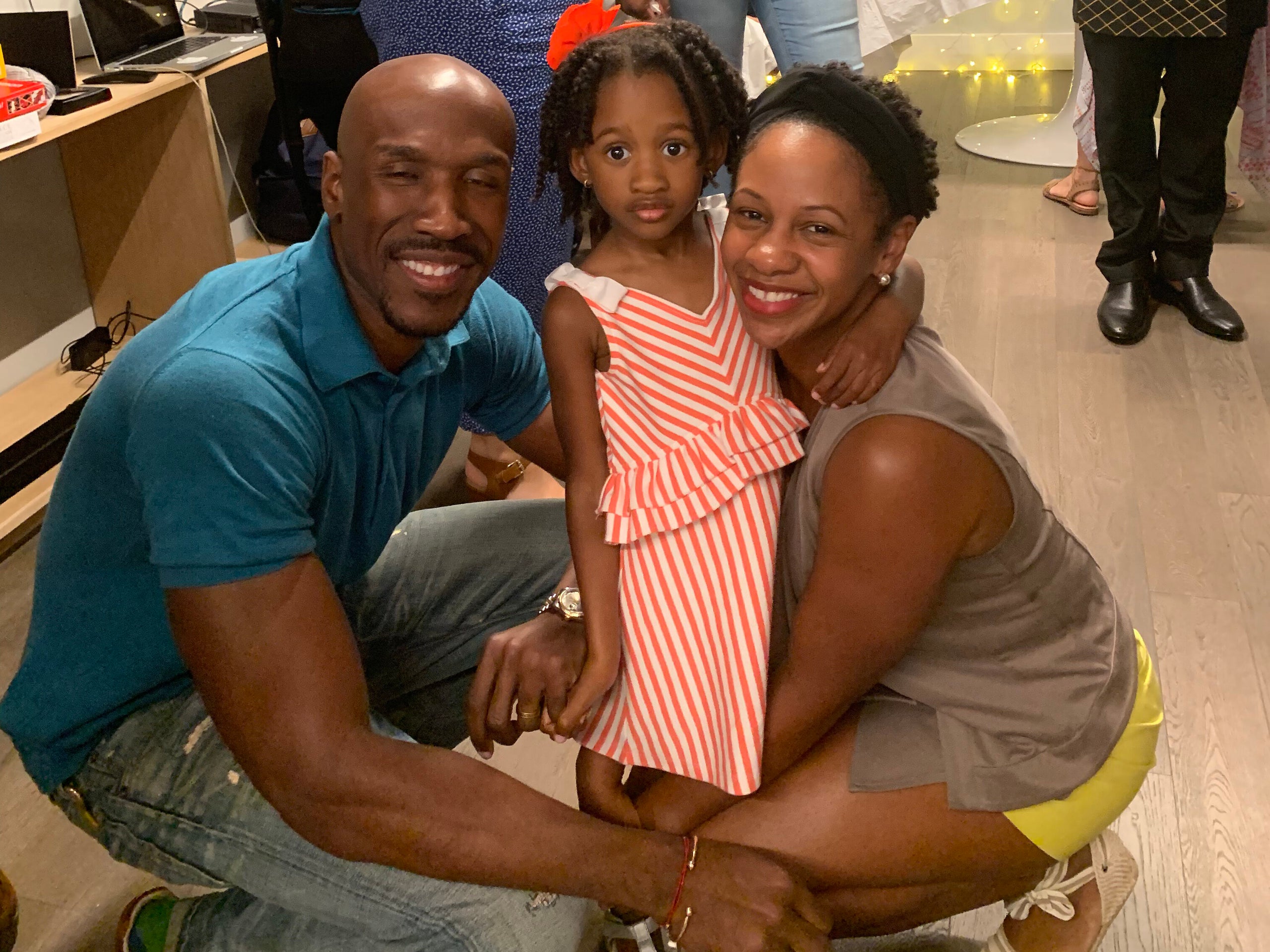 Ernest, Presley and Tamiesha Parris pose for a family photo at a small gathering in Queens, back when such gatherings were a