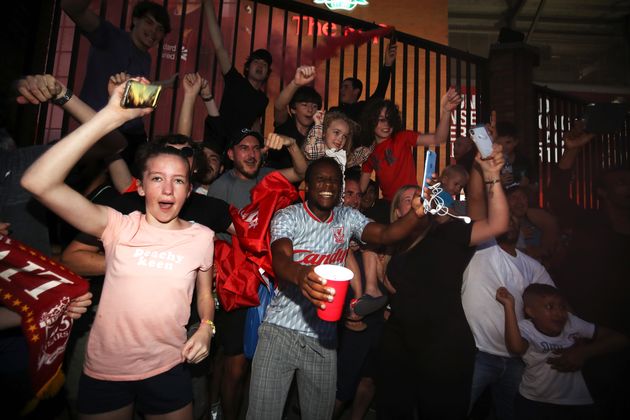 Liverpool fans celebrate outside Anfield, Liverpool.