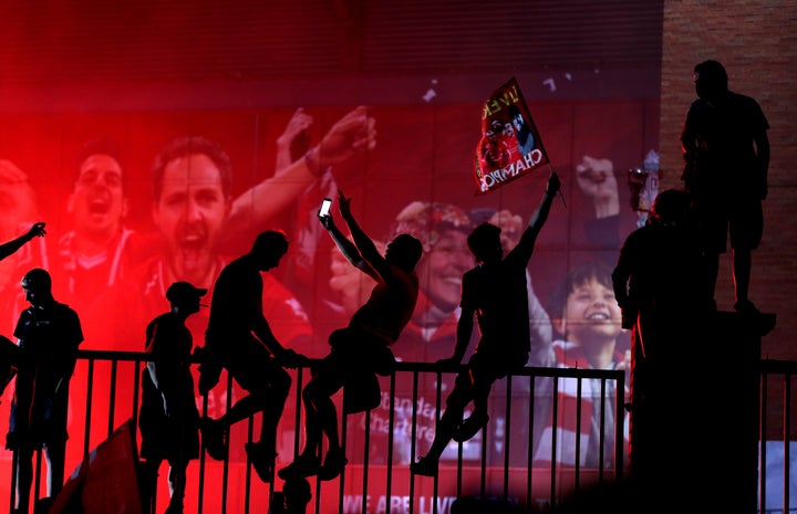 Liverpool fans celebrate outside Anfield, Liverpool.