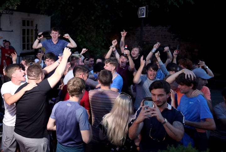 Liverpool fans celebrate outside in Liverpool after they are crowned Premier League champions after Manchester City lost 2-1 against Chelsea.