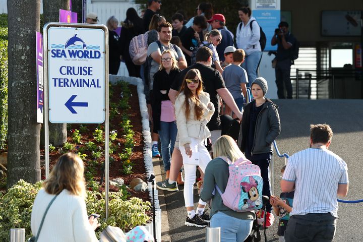 GOLD COAST, AUSTRALIA - JUNE 26: Crowds line up to enter Seaworld on June 26, 2020 in Gold Coast, Australia. Sea World has reopened to the public with extra safety and hygiene measures in place following its temporary closure on 23 March 2020 due to the COVID-19 pandemic. Visitors to Sea World must observe physical distancing rules and provide details for contact tracing purposes. Increased sanitisation of high touch areas throughout the park have been introduced along with contactless payments. 