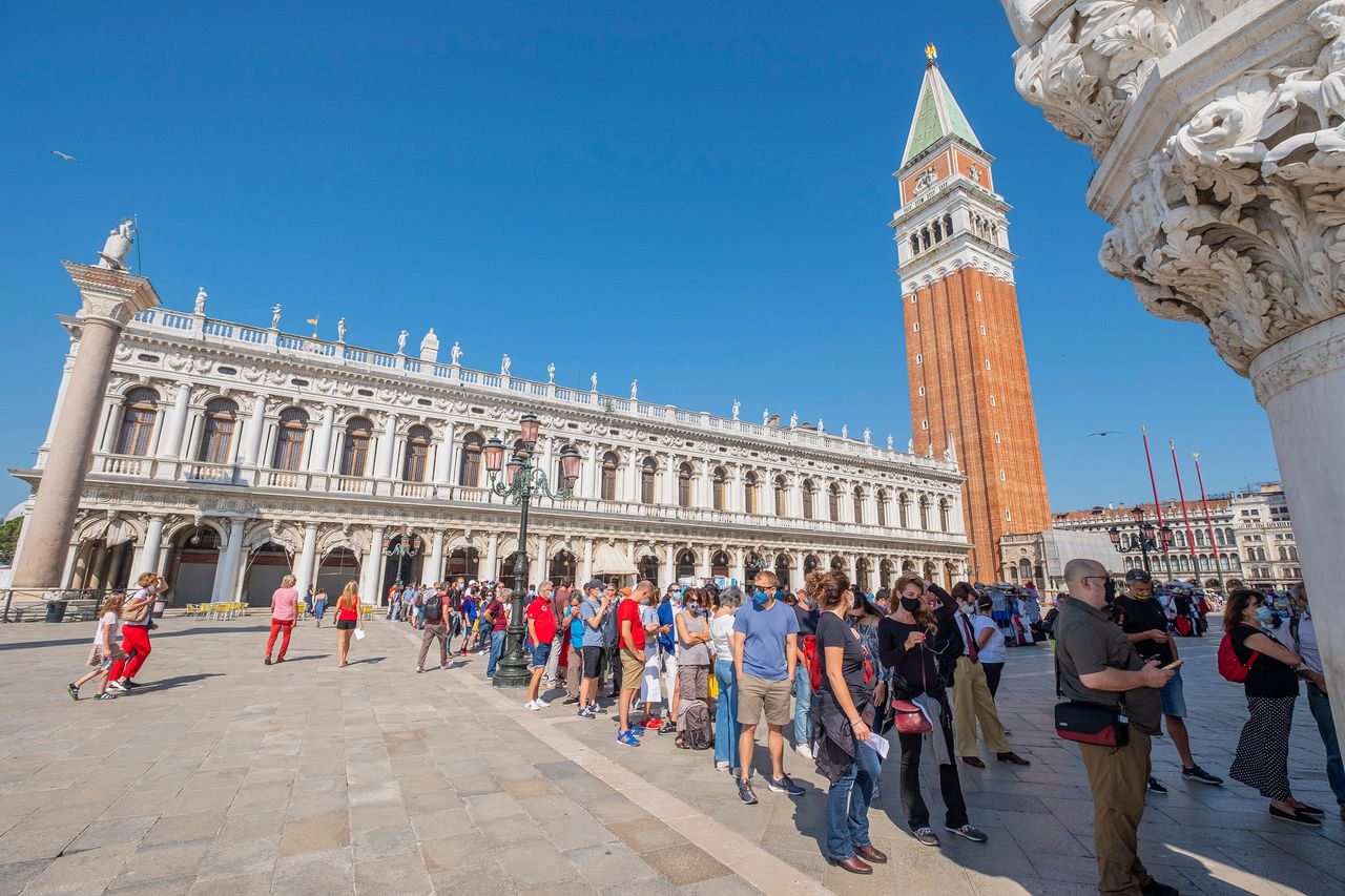 Tourists wait to enter the Doge's Palace in Venice, Italy, on the day of its reopening, June 13.