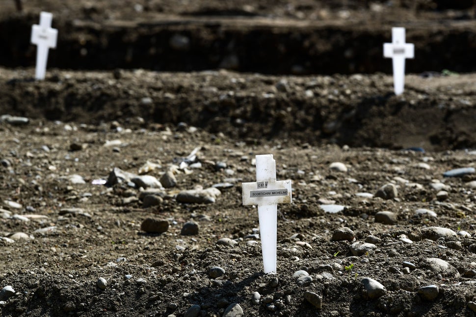 At the Maggiore cemetery in Milan, graves of unclaimed coronavirus victims are marked with a simple plastic cross, April 23, 2020.