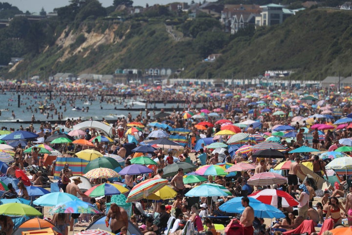 Crowds gather on the beach in Bournemouth as the UK experience a heat wave, in Bournemouth, England, Thursday, June 25, 2020. (Andrew Matthews/PA via AP)