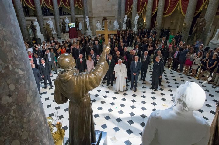 Pope Francis pauses in front of a sculpture of Junipero Serra in Statuary Hall at the U.S. Capitol in Washington on Sept. 24, 2015.