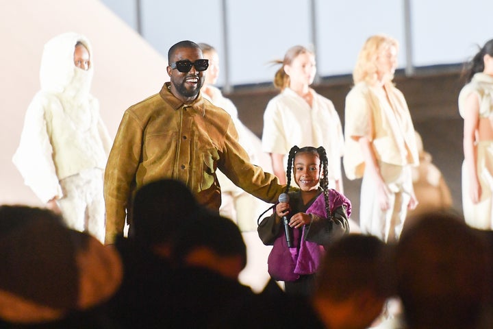 Kanye West and his daughter North West on the runway during the "Yeezy Season 8" show in March in Paris. West is starting a line of more affordable fashion with Gap.