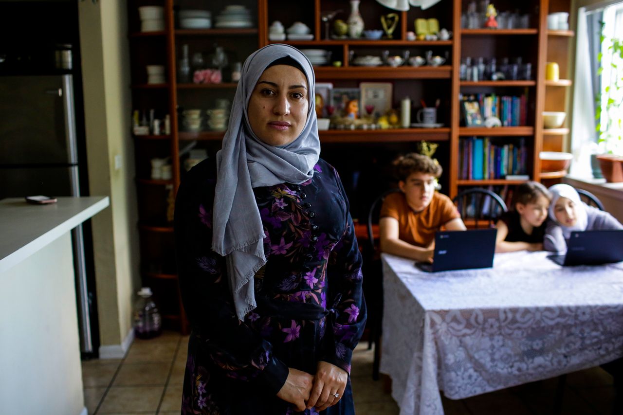 Nawar Almadani, a Syrian refugee, poses for a portrait in her apartment during the COVID-19 outbreak on June 24 in Chicago, Illinois. Nawar's children now participate in school classes remotely on their computers.