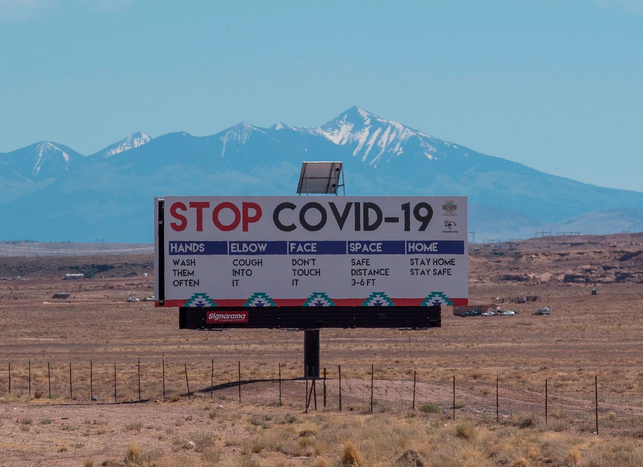 A sign warns against the COVID-19 virus near the Navajo Nation town of Tuba City, Arizona, on May 24.