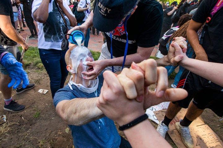 Milk is poured into a demonstrator's eyes to neutralize the effect of pepper spray during a rally at Lafayette Park near the White House on May 31, 2020.