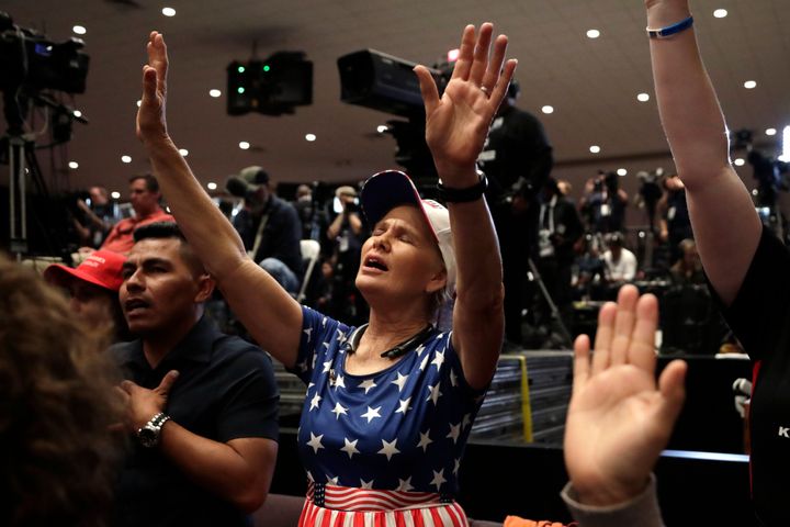 Wanda Albritton of Miami Springs, Florida, raises her arms in prayer at a rally for evangelical supporters at the King Jesus International Ministry church on Jan. 3 in Miami.