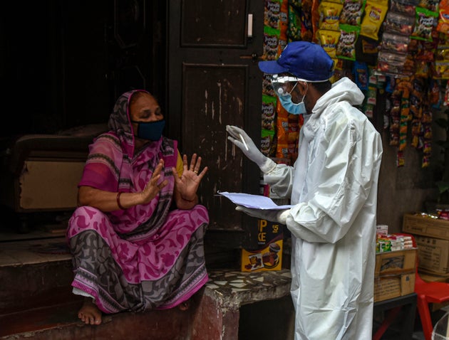 A health worker in PPE conducts a door to door screening survey for coronavirus in Karol Bagh's Ragarpura...