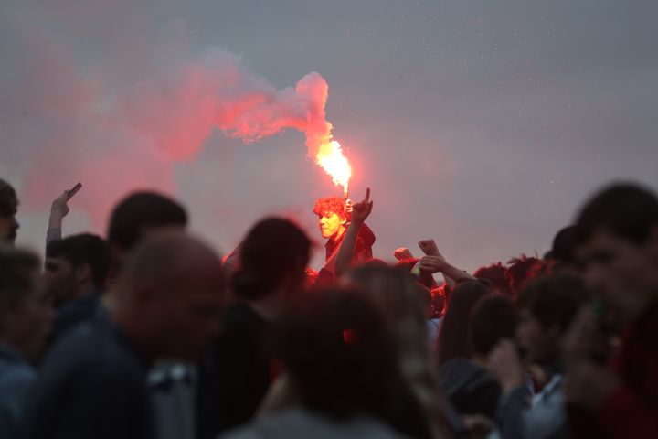 Liverpool fans let off flares outside the Liver Building in Liverpool on Friday evening.