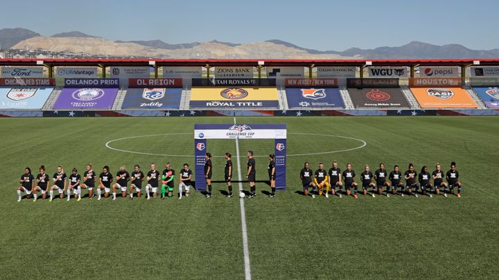 Players for the Portland Thorns, left, and the North Carolina Courage kneel during the national anthem before the start of their NWSL Challenge Cup soccer match at Zions Bank Stadium Saturday in Herriman, Utah. (AP Photo/Rick Bowmer)
