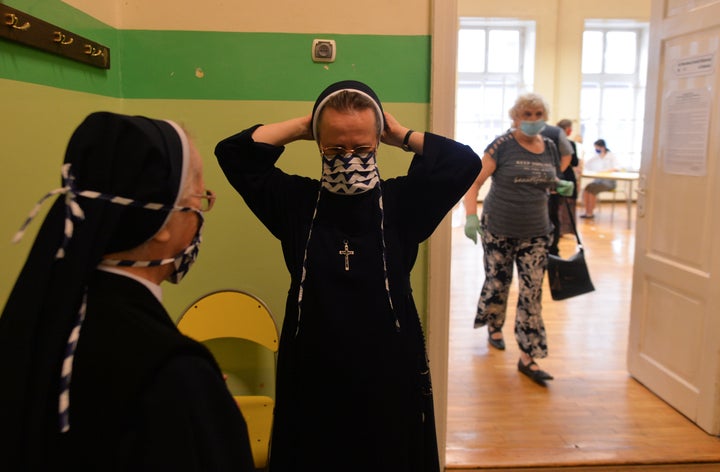 The first voters arrive to cast their votes in the first round of presidential elections in Krakow.